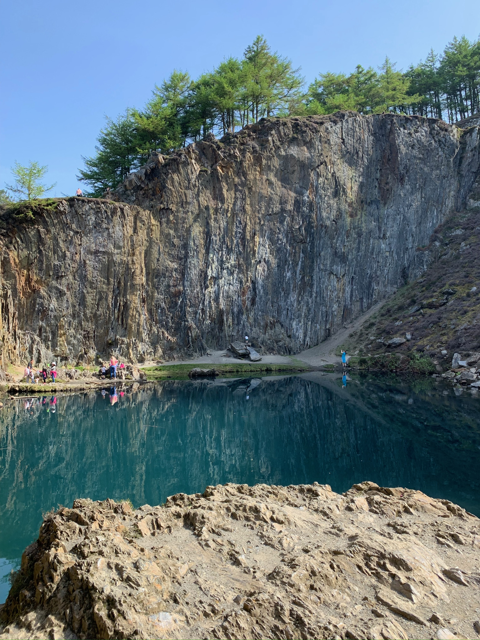 Natural quarry with turquoise water and cliff faces